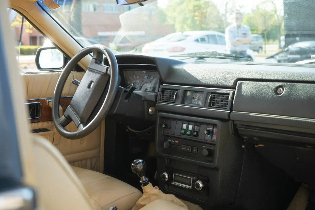the interior of a car with a dash board and steering wheel