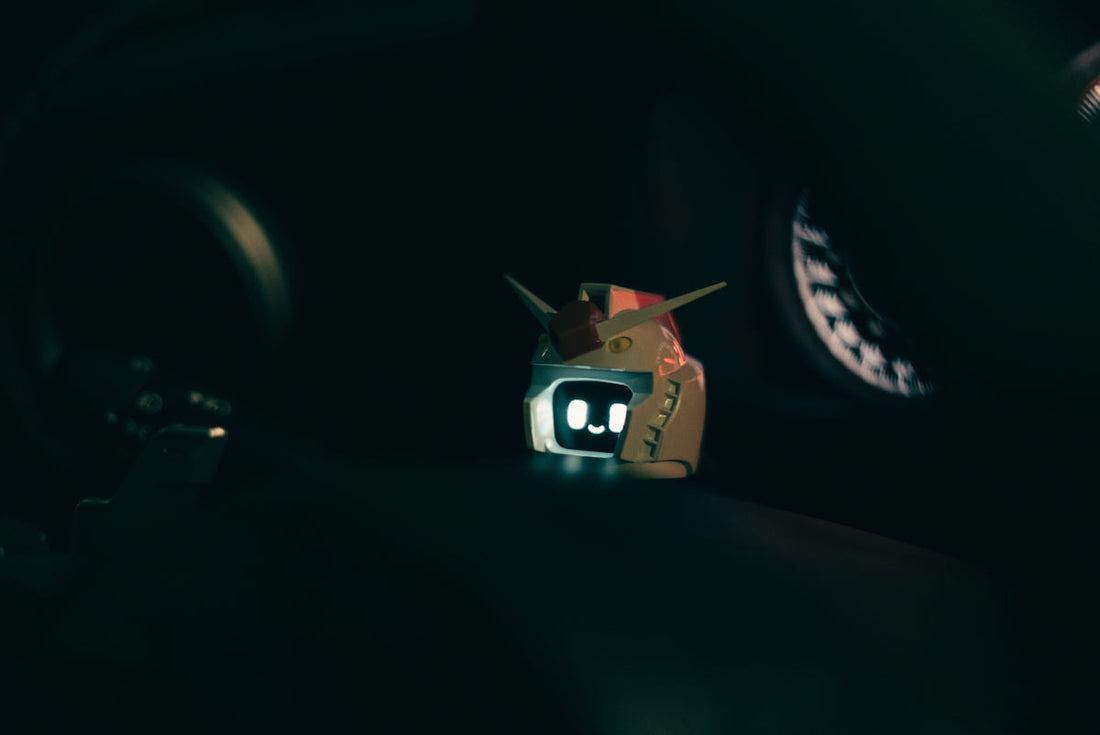 A small toy is sitting on the dashboard of a car