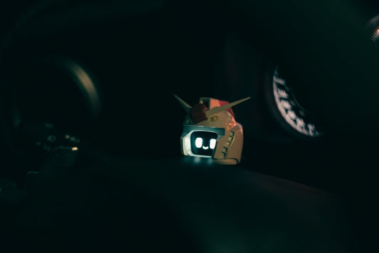 A small toy is sitting on the dashboard of a car