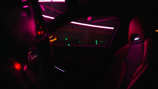 the interior of a car is lit up with red and green lights
