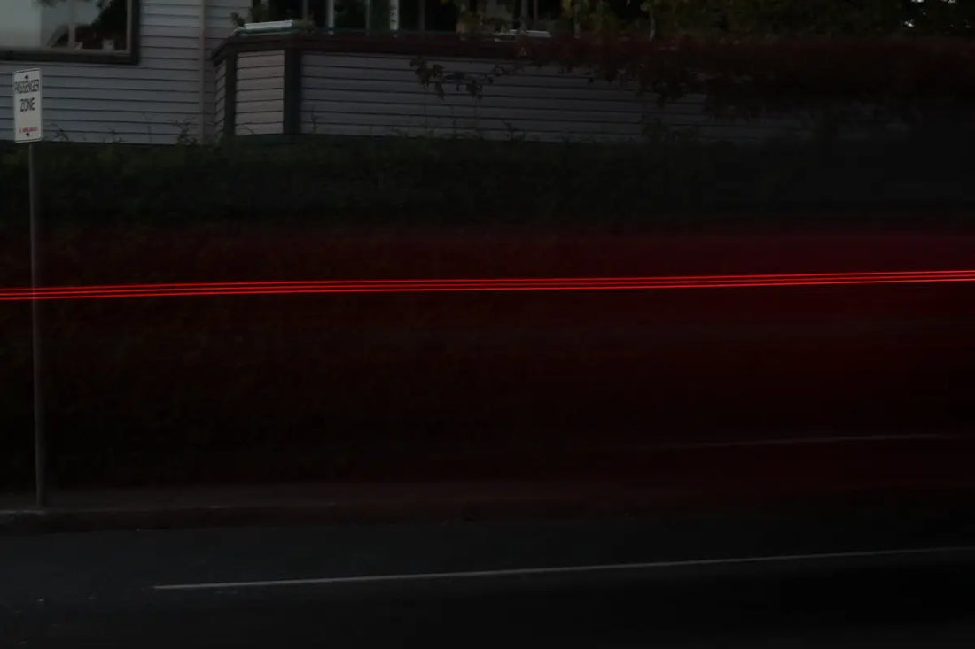 a blurry photo of a street with a house in the background