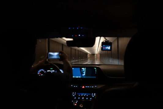 Someone inside of a car is filming a tunnel.