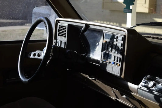 a dashboard of a car with a steering wheel