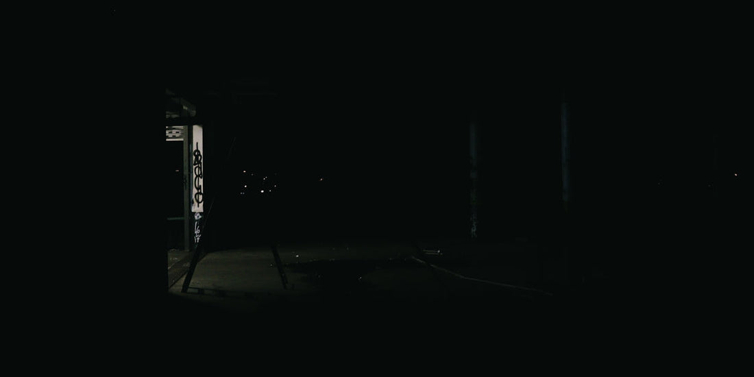 A dark room with a door and a window