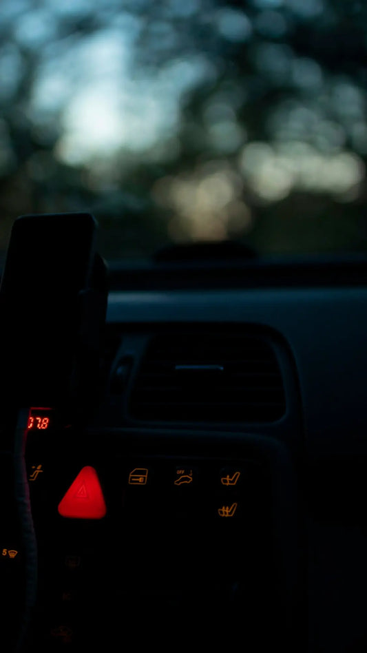 the dashboard of a car with a cell phone in it